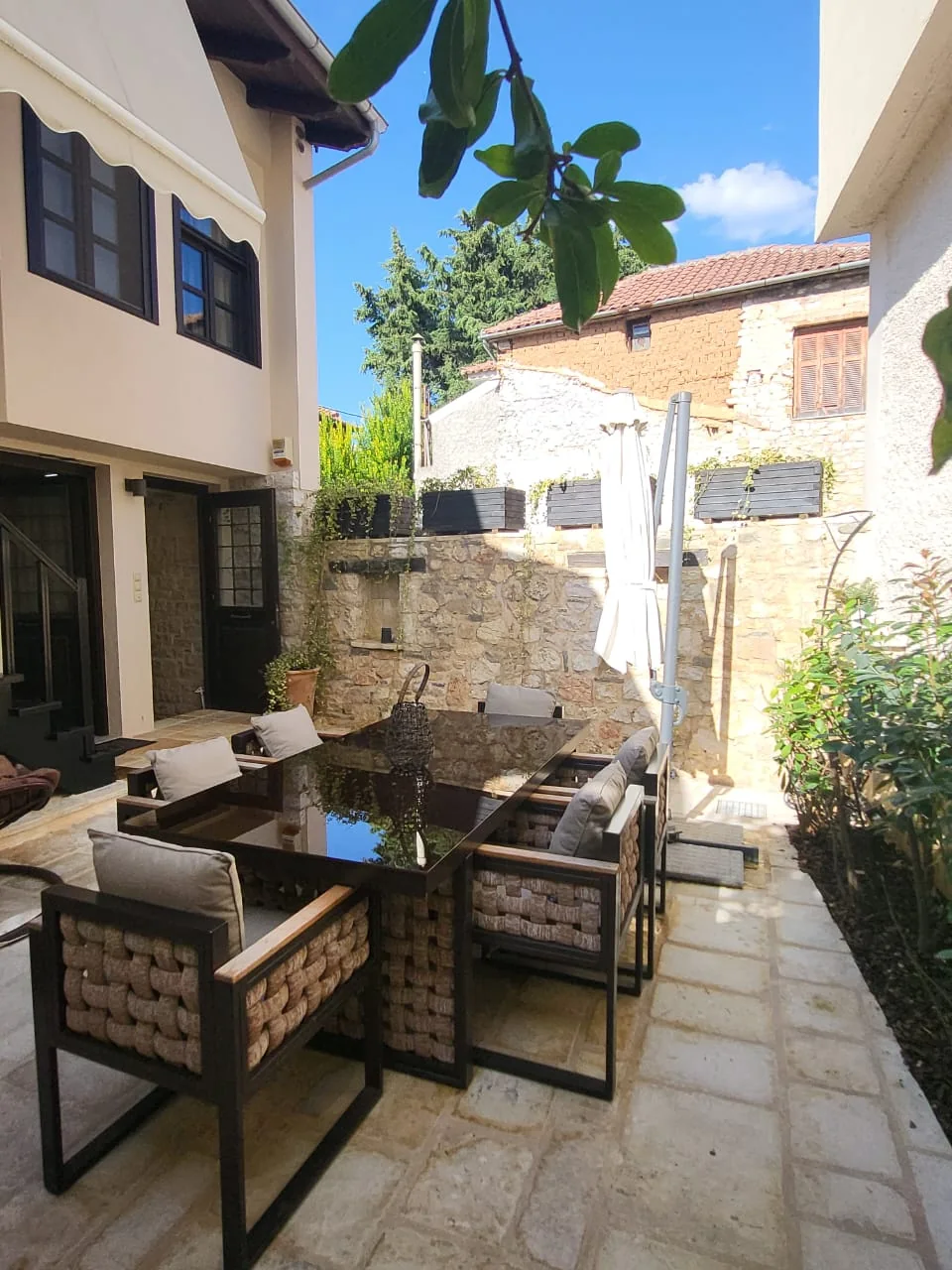 Jeneli Castle stone courtyard with outdoor dining and flowers