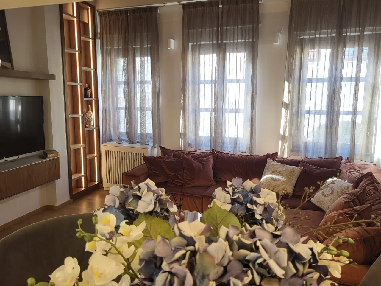 Jeneli Castle elegant living area with sofa and warm wood finishes